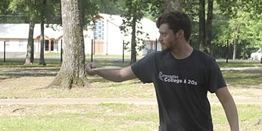 student playing disc golf