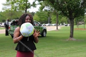 Jasmine McGee of Jackson attempts to make the Earth ball into the recycling bin to win candy during Earth Day at the Hinds Community College Rankin Campus.