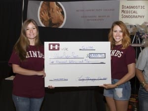 From left, Angela Dewey and Melody Rayborn Block, both students in the Diagnostic Medical Sonography program, hold a check for $2,000 to the Warrior Bonfire Project from the Nursing/Allied Health Center as part of this year’s community outreach service project.