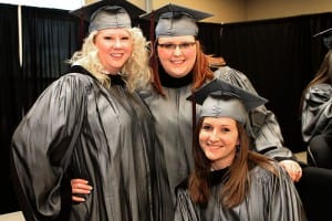 Morgan Currington of Vicksburg, sitting, Colie Hollowell of Vicksburg, standing left, and Clair Myers of Terry graduated from Hinds Community College on Dec. with degrees in dental assisting.