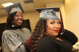 Tyeshia Harrington of Brandon, left, helps Samantha Brown of Ridgeland with her cap at the Dec. 18 graduation at Hinds Community College. They graduated with degrees in phlebotomy.