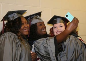 Practical nursing graduates Khadijah Anderson of Vicksburg; left, Shamone Byest of Belzoni and Tammy Barrett of Vicksburg take a selfie before their ceremony on Friday, Dec. 16 at Hinds Community College’s Muse Center on the Rankin Campus.