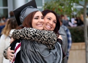 Amanda Lumm of Terry, left, is engulfed in a hug by her best friend Brittany Ross after receiving her dental assisting degree from Hinds Community College on Dec. 16.
