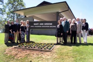 Dr. Mary Ann Greene and her family near the sign of the renamed Early Childhood Education Building (Hinds Community College/Tammi Bowles)