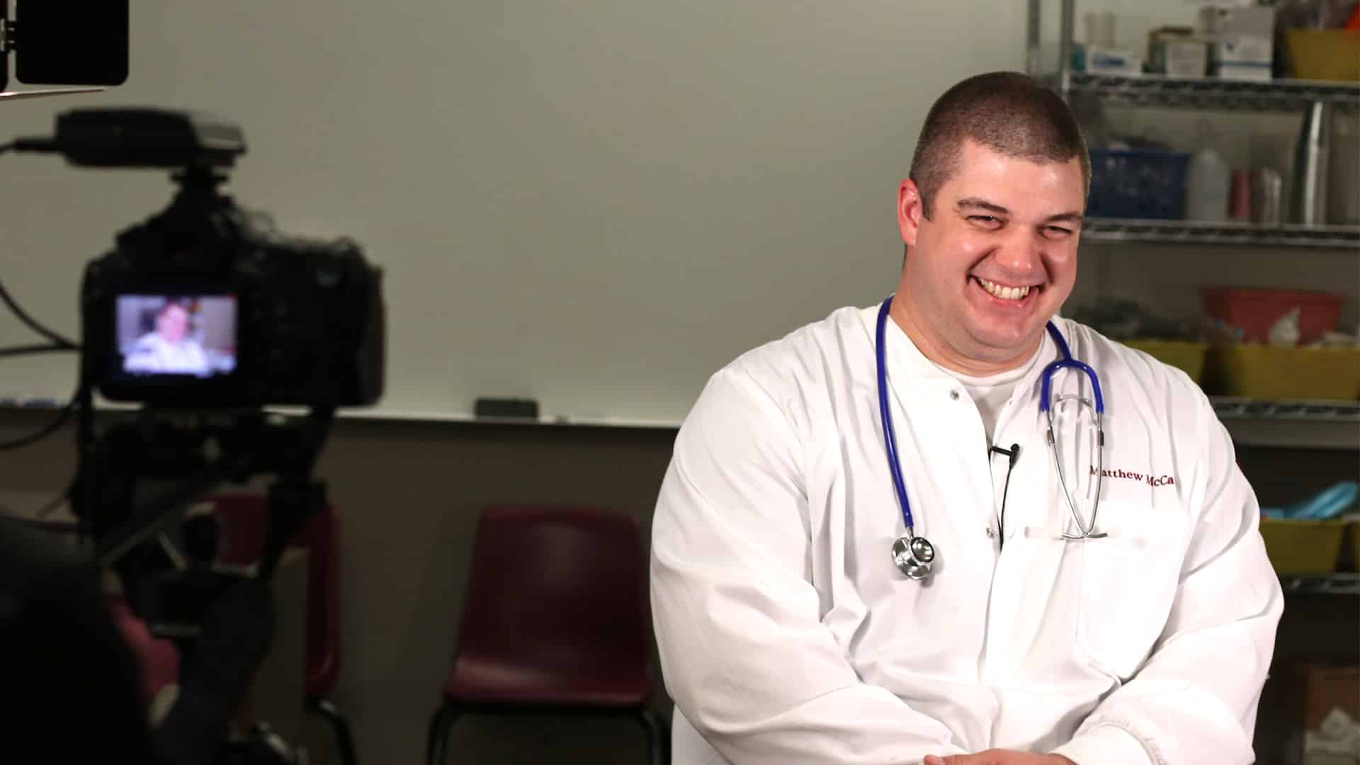 male nursing students laughing during interview