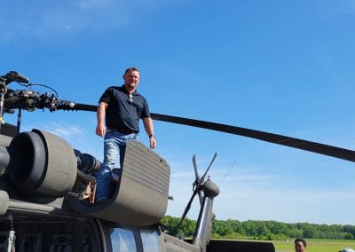 Aviation maintenance instructor standing on top of a black hawk helicopter
